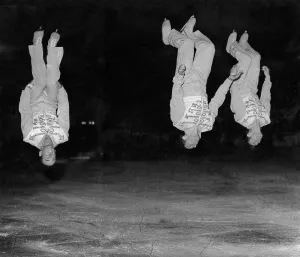 Acrobats Prints: The Mullen twins and Raiche nIce-Crobats in a back somersault during the nIce-Cycles of