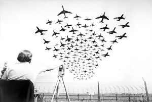 00091 Prints: Multiple aircraft coming into land at Heathrow Airport with man sitting down monitoring