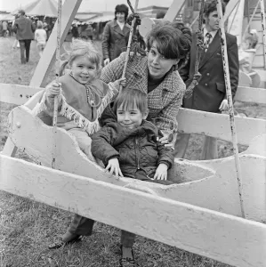 Fairs And Fairground Rides Prints: Mum with son and daughter enjoying the swings at Silcocks Fair at Skelmersdale 17th May