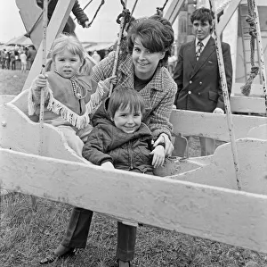 Mum with son and daughter enjoying the swings at Silcocks Fair at Skelmersdale 17th May