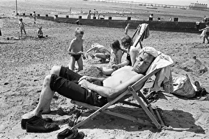 Holidaymaker Prints: Mum watches the children build sand castles as dad with his knotted handkerchief sun hat