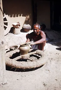 00134 Prints: Muria tribal (Gonds) forming clay pot at Narainpur Bastar District MP India