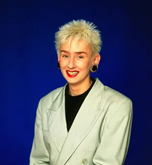 Muriel Gray TV presenter wearing beige jacket and black jumper top earrings