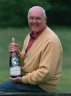 Images Dated 8th July 1997: Murray Walker Motoracing Commentator July 1997 holding bottle of champagne