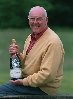 Murray Walker Motoracing Commentator July 1997 holding bottle of champagne
