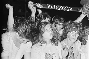 Young Prints: Music Fans at The Reading Festival, clapping along and enjoying the moment as the bands