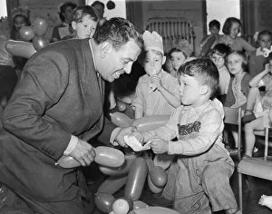 Kneeling Prints: Music Hall comedian Hal Monty seen here entertaining the children of the Pendlebury