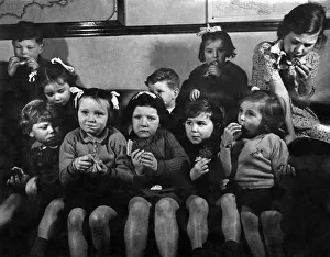 Rationing Prints: My! It looks good but tastes better. Children seen here enjoy a piece of fruit cake
