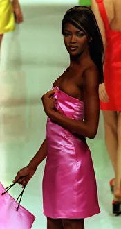 Strapless Prints: Naomi Campbell models designs by the designer Genny October 1995