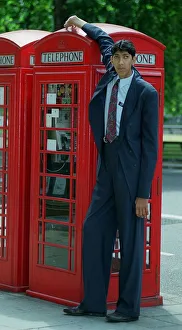 Naseer Ahmed Soomro claims to be World Tallest Man 1999 stands next to a red