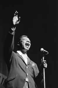 Nat King Cole sings at The Royal Variety Show held in the presence of her Her Majesty