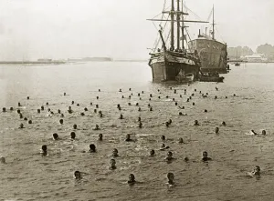Naval cadets taking a swim around the Training ship Mercury a former Royal Navy ship of