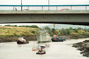 Former Navy Minehunter HMS Kellington being towed underneath the Princess of Wales Bridge