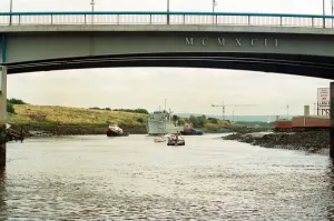 Former Navy Minehunter HMS Kellington being towed underneath the Princess of Wales Bridge