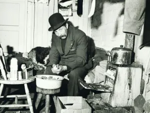 Bowler Hat Prints: Ned Webb peeling a potato in his small room adjoining a disused stable on a deserted farm