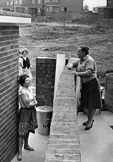 Talking Prints: Neighbours Mrs Moria Foster (left) and Mrs Phillis Tanner chat over the garden wall