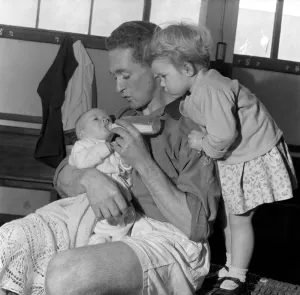 Neil Dougall (Plymouth Argyle) feeds his children in football dressing room