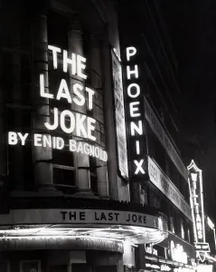 Neon lights advertise the play The Last Joke