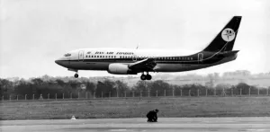 Landing Prints: A new Dan-Air Boeing 737 lands at Newcastle Airport as a workman works on an adjoining