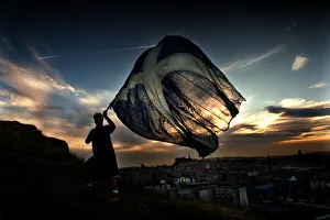 New Dawn September 1997 a man holding waving a Saltire flag at sunrise in Edinburgh