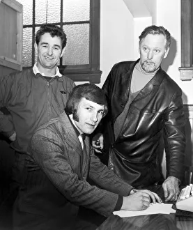 Transfer Prints: New Derby County signing Colin Todd finishes off the signing formalities watched by