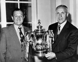 New Liverpool manager Bob Paisley (left) and retiring manager Bill Shankly pose with