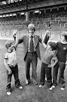 Transfer Prints: New Liverpool signing Kenny Dalglish with fans on the pitch at Anfield as he completes