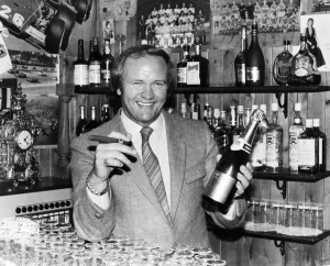 Award Ceremonies Prints: New Manchester United football manager Ron Atkinson holds up a bottle of champagne in one