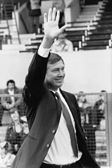 New Manchester United manager Alex Ferguson waves to the crowd before his first match in