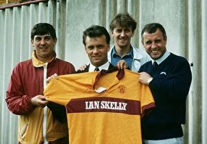 Images Dated 15th August 1989: New Motherwell signing Davie Cooper poses with the team shirt as he stand with management