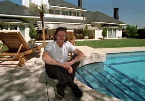 New Real Madrid signing Steve McManaman sitting beside the pool at his new home in Madrid