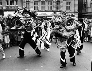 Dragon Prints: New Year Chinese style. A festive Dragon dance underway at Greys Monument, Newcastle