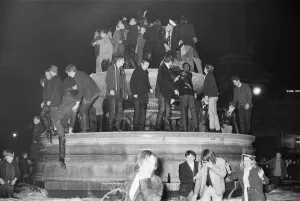 Square Prints: New Years Day 1967. Young people celebrate in the fountains at Trafalgar Square, London