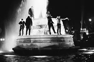01025 Prints: New Years Day 1967. Young people celebrate in the fountains at Trafalgar Square, London