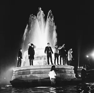 01025 Prints: New Years Day 1967. Young people celebrate in the fountains at Trafalgar Square, London