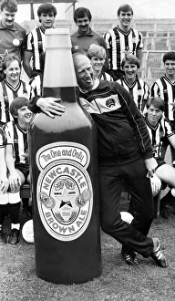 Funny Prints: Newcastle United manager Jack Charlton clowns around with a giant bottle of Newcatle