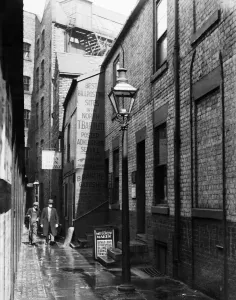 Lamp Post Prints: Newcastles early morning workers walk through the lighted Forth Lane in