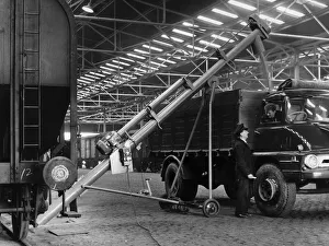 A newly installed grain elevator is seen transporting from wagon to lorry at British