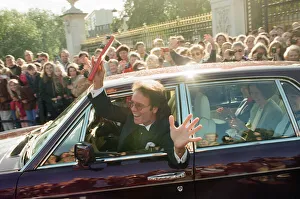 01198 Prints: A newly-knighted Sir Cliff Richard leaves Buckingham Palace waving his gong aloft