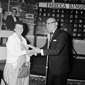 00115 Prints: Newsagent Mrs Helen Retter picks up up her £83 prize money after a winning night