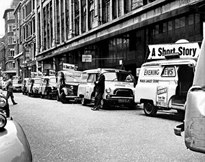 Communication Prints: Newspaper printing. Delivery vans of the London evening News wait for the paper to roll