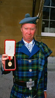 Tartan Prints: Nicholas Fairbairn politician February 1988 holding meal award