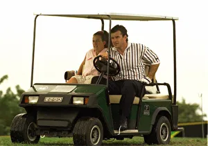 Nick Faldo gives his caddie Fanny a lift in a golf car in Jamaica