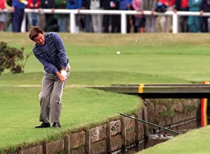Nick Faldo plays over the Swilken burn at the 1st after putting his ball in the water in