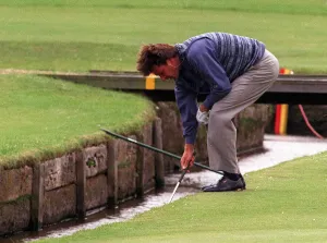 Stream Prints: Nick Faldo retrieves his ball from the Swilken burn at the 1st after putting his ball in