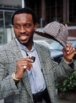 Nigel Benn intweed jacket holding hat and pipe March 1990