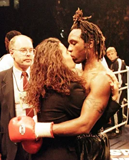 Nigel Benn kisses his girlfriend after his defeat by Steve Collins for WBO super
