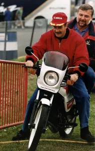 Nigel Mansell Motor Racing Driver Formula One F1 riding a Motor Cycle