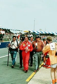 00194 Prints: Nigel Mansell Motor Racing Driver Formula One F1 walks from the Silverstone Track after