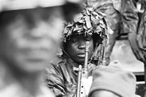 Nigeria Prints: A Nigerian army soldier tries to catch 40 winks in the back of the lorry going to